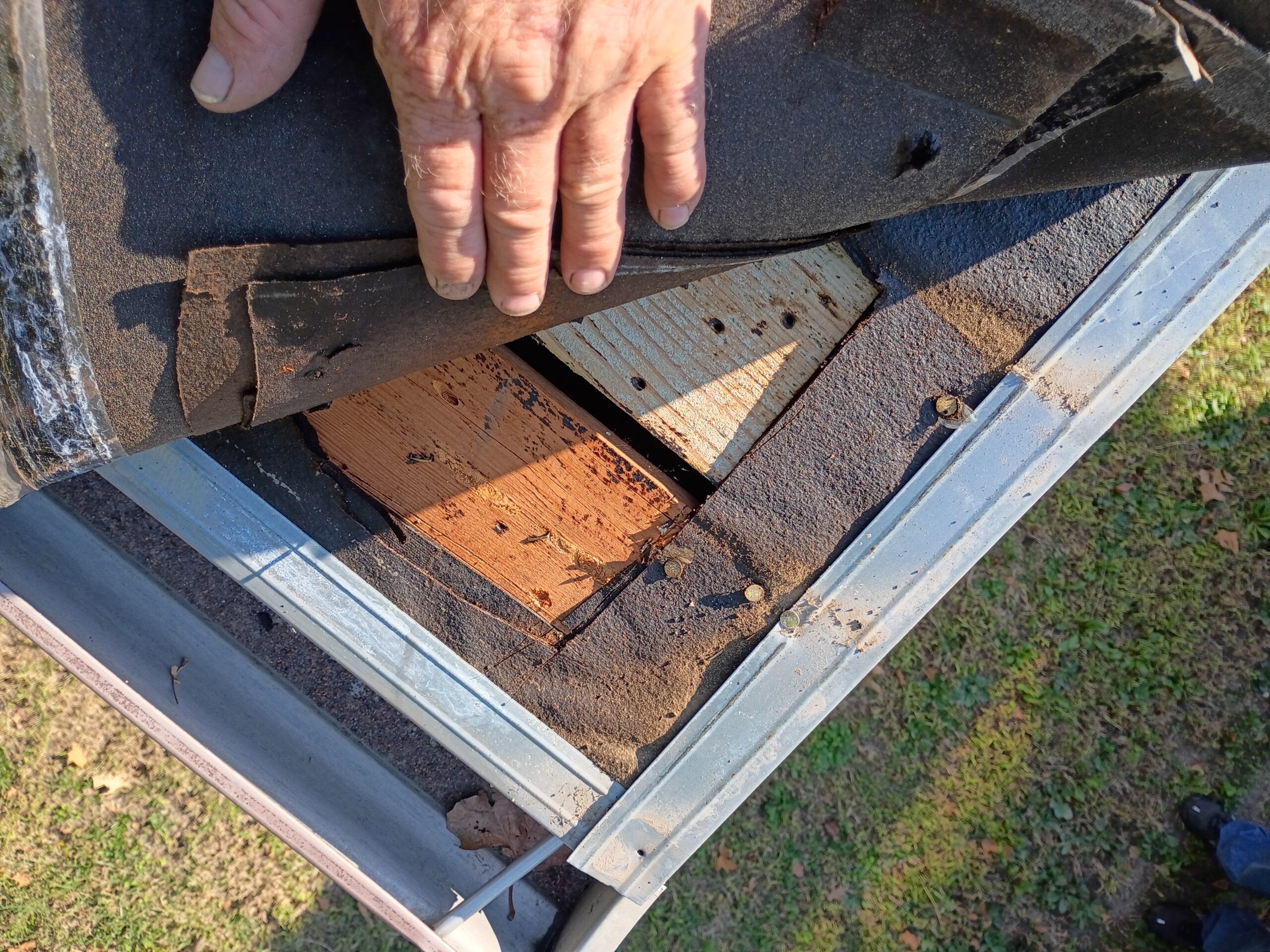 Roof decking exposed during an Agape Construction roofing inspection and repair project